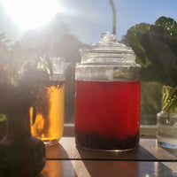 An excellent sun tea as well, the Jamaican Sorrel tea catches a sunrise with fellow basil, greens and flowers. The tea is a deep ruby red and its in a glass jar that allows the sun to activate the tea. 